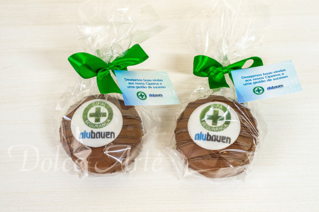 Pães de Mel decorados com a logo da empresa, embalados em celofane com fita e tag personalizada para evento corporativo